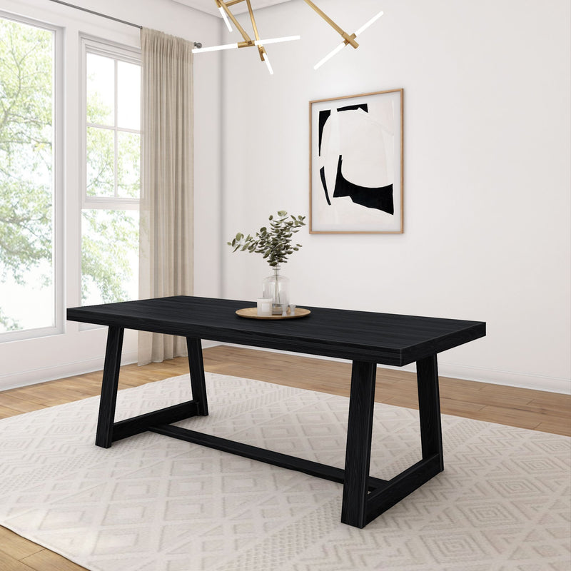 Contemporary dining room with black modern table, geometric chandelier, abstract wall art, and large window.