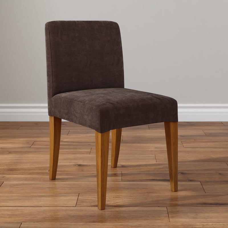 Modern brown upholstered dining chair with oak wooden legs on hardwood floor
