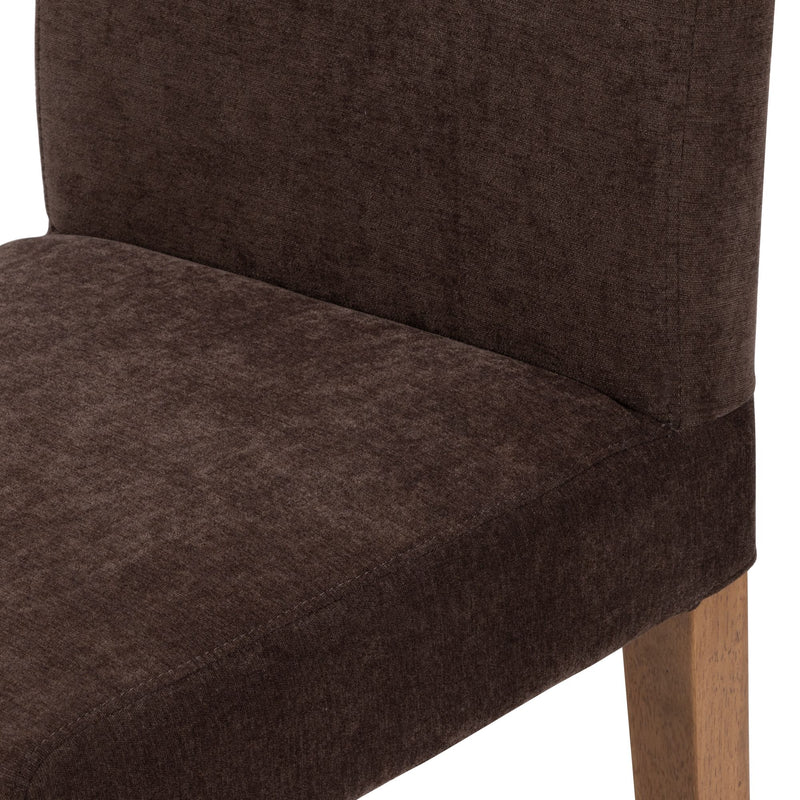 Close-up of a brown upholstered dining chair showing soft textured fabric on the seat and back with light wood legs, modern dining chair detail