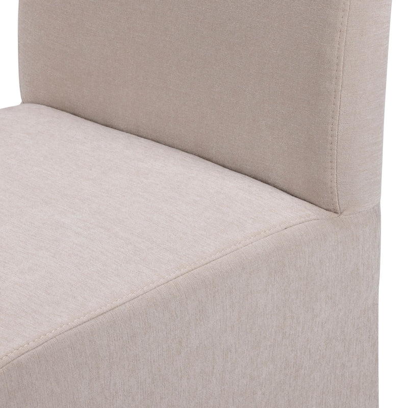 Close-up of beige upholstered dining chair showing linen-like fabric texture and stitching detail on a modern armless seat and back