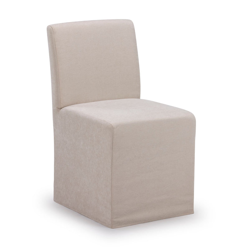 Beige upholstered armless dining chair with full skirted slipcover, cushioned seat and curved back, modern farmhouse style.