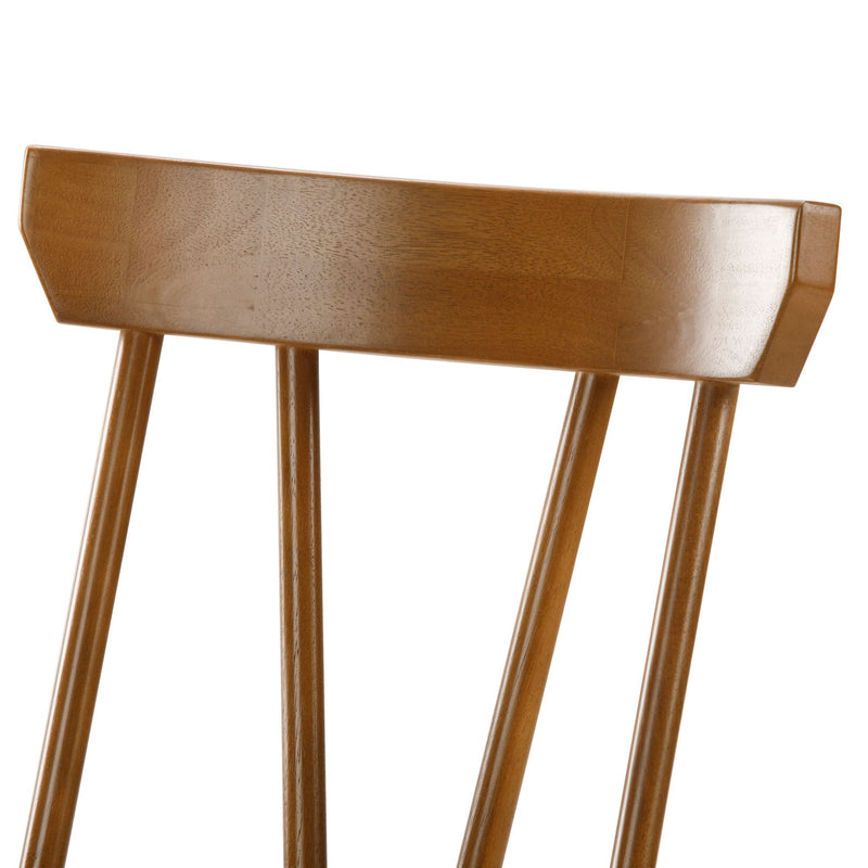 Close-up of mid-century modern wooden dining chair back with vertical spindles, walnut finish and polished wood grain
