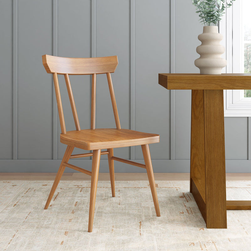 Scandinavian minimalist interior with wooden dining chair, oak table and sculptural ceramic vase by window against gray paneled wall
