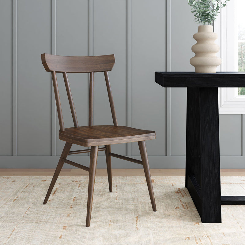 Modern wooden chair beside a minimalist dining table in a stylish room setting.