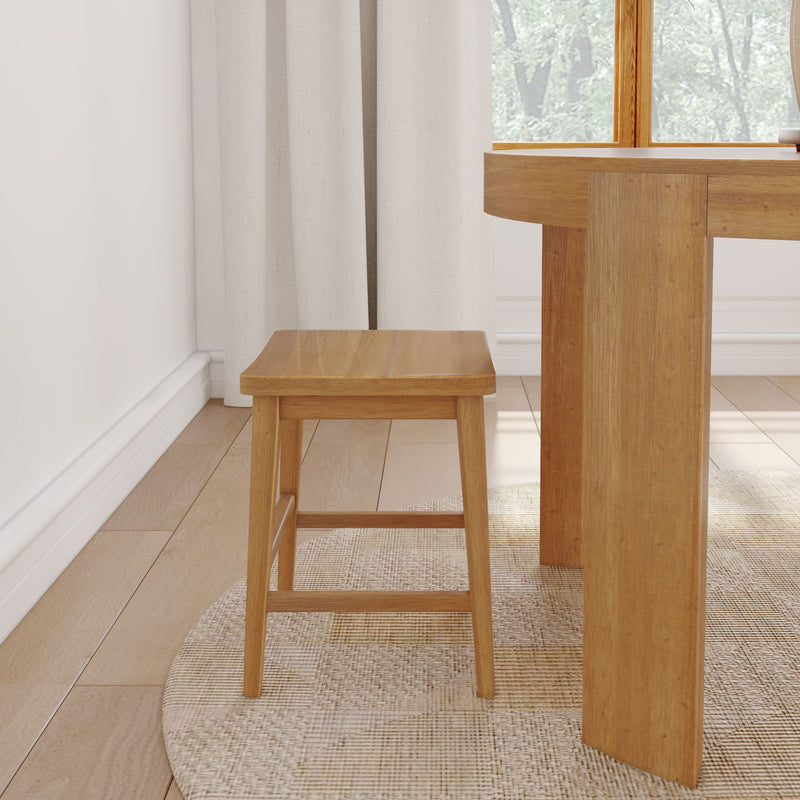 Wooden stool next to a wooden dining table in a bright, modern living room.