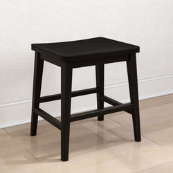Black wooden backless stool with square seat and crossbar footrest on hardwood floor, modern farmhouse counter/kitchen stool