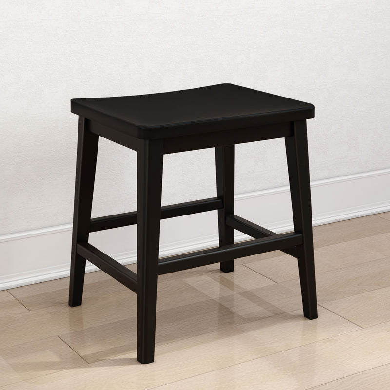 Black wooden backless stool with square seat and crossbar footrest on hardwood floor, modern farmhouse counter/kitchen stool