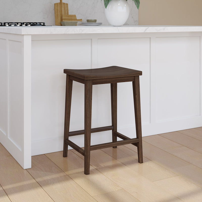 Wooden bar stool next to a modern white kitchen island with marble countertop.