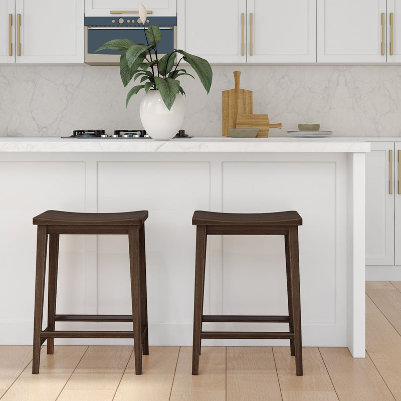 Modern kitchen island with white cabinets and two dark wooden bar stools.