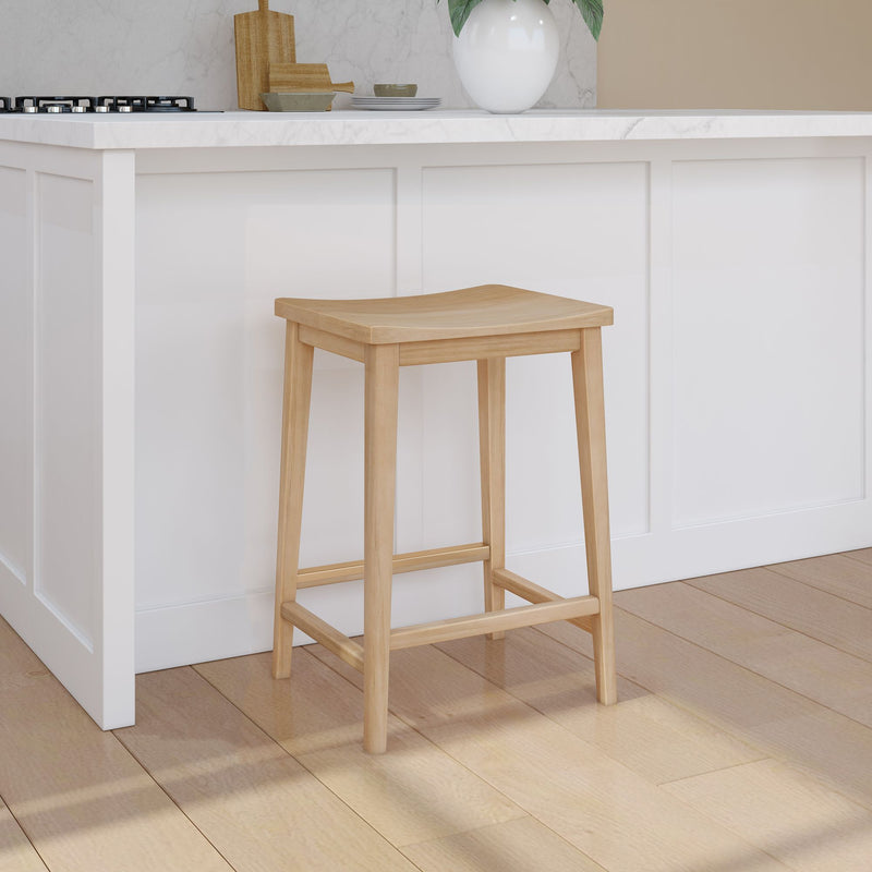 Natural wood bar stool in modern kitchen with white cabinetry and marble countertop.