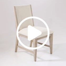 Beige upholstered wooden chair with a minimalist design on a white background.