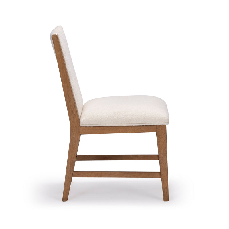 Side view of a modern wooden dining chair with cream upholstery.