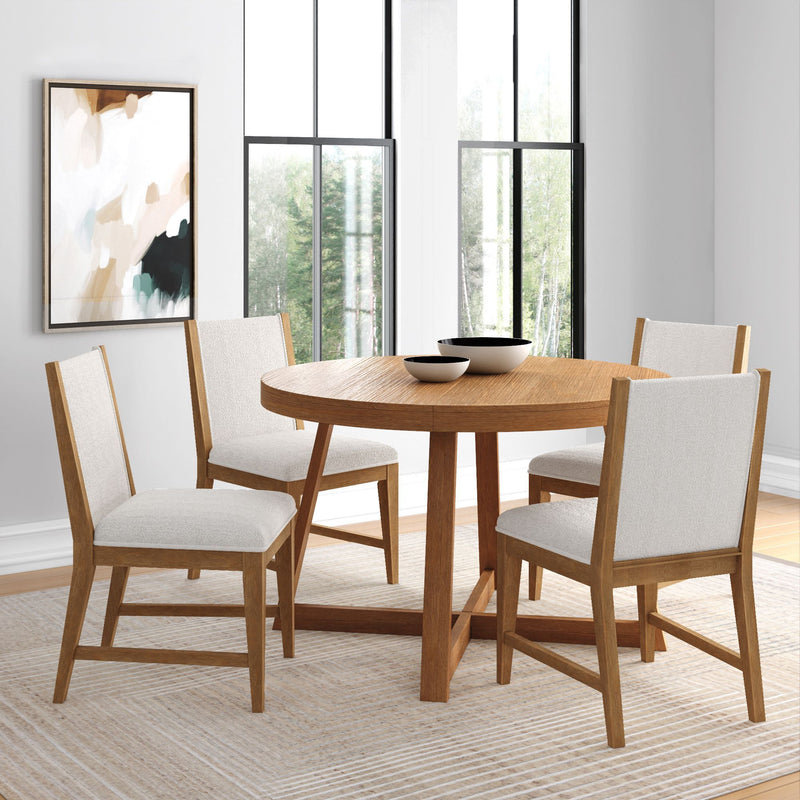 Modern dining room with a round wooden table and four upholstered chairs, featuring large windows and abstract wall art.