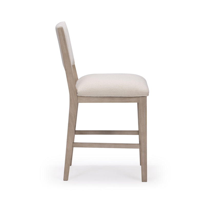 Side view of modern wooden dining chair with white cushioned seat.
