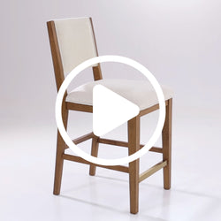 Wooden bar stool with white cushioned seat and backrest on gray background.