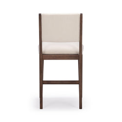 Elegant wooden dining chair with cushioned seat and backrest in cream fabric.