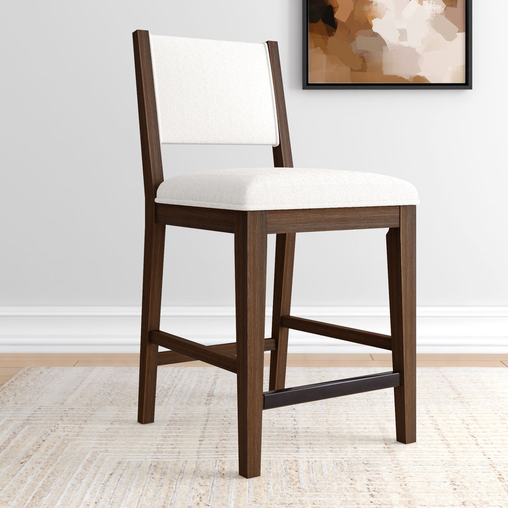 Elegant wooden dining chair with white upholstery on hardwood floor in modern interior.