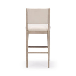 Tall wooden bar stool with beige upholstery, back view on white background.