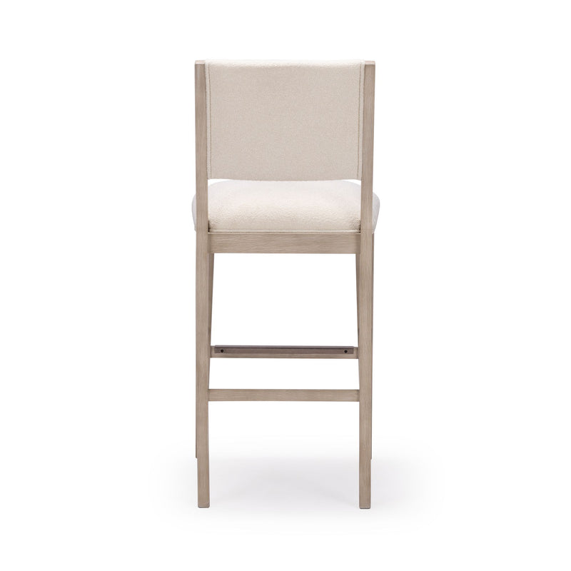 Tall wooden bar stool with beige upholstery, back view on white background.