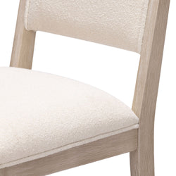 Modern beige cushioned dining chair with wooden frame.