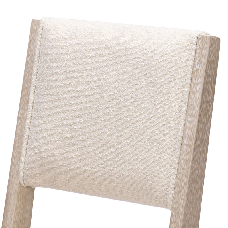 Cream fabric upholstered modern chair back with light wood frame.