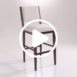 Modern white upholstered counter-height bar stool with low back, dark wood frame and footrest, stylish kitchen island seating