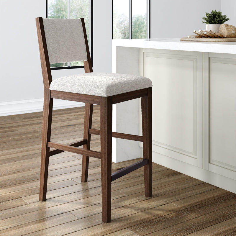 Modern wooden bar stool with white cushioned seat in a contemporary kitchen setting.
