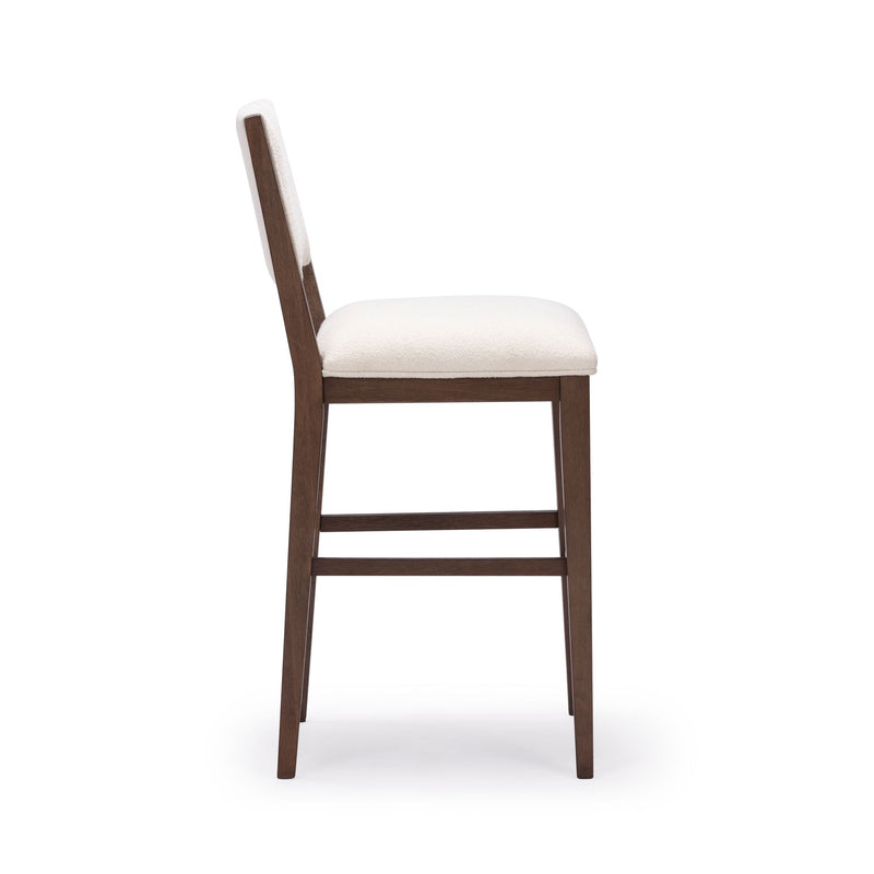 Brown wooden barstool with white cushioned seat and backrest, side view.