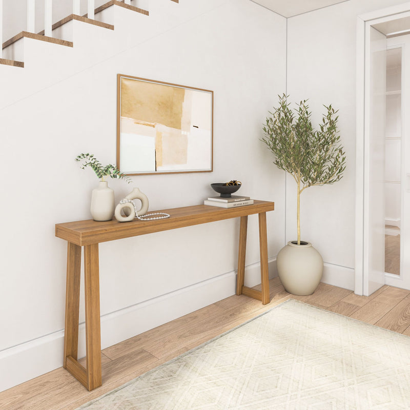 Modern minimalist entryway with wooden console table, decorative vases, abstract wall art, and elegant potted plant.