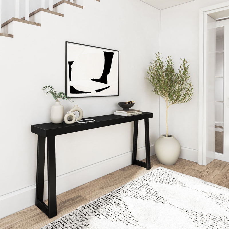 Modern entryway with black console table, abstract wall art, and decorative items for contemporary home decor.