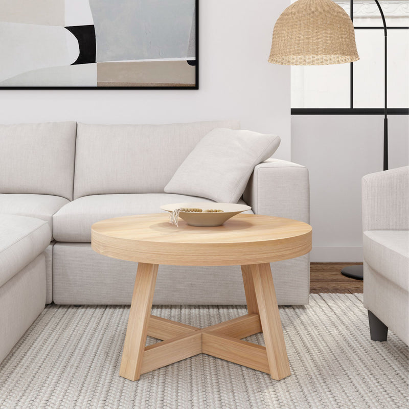 Modern living room with beige sofa, wooden coffee table, decorative bowl, and abstract wall art.