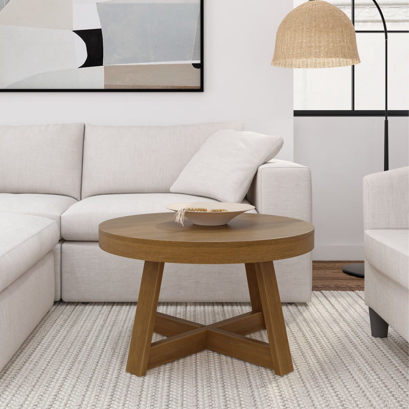 Modern living room with a round wooden coffee table, white sectional sofa, and contemporary decor.