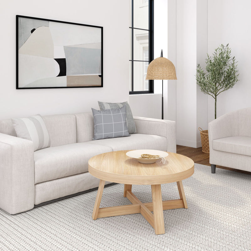 Modern living room with beige sofa, wooden coffee table, abstract wall art, and decorative indoor plant.