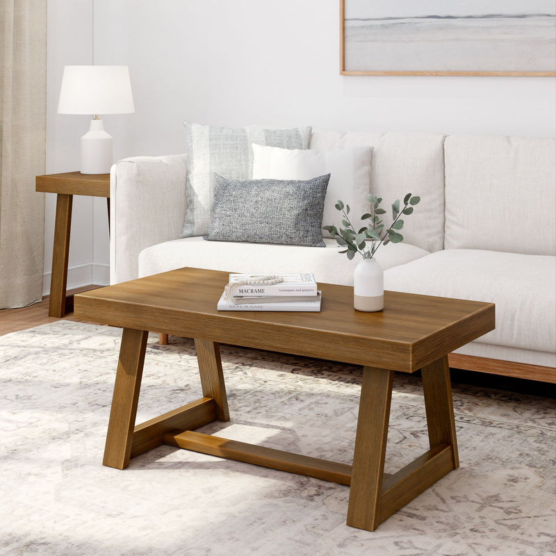 Mid-century modern living room with wooden coffee table, white sofa, and decorative pillows.