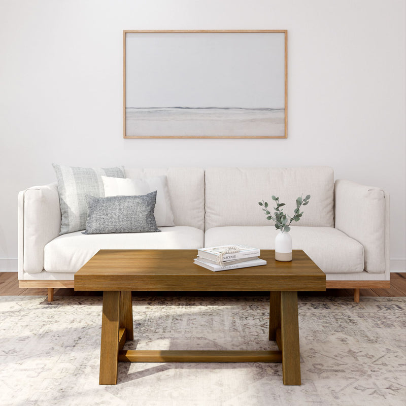 Modern living room with beige sofa, wooden coffee table, and minimalist decor.
