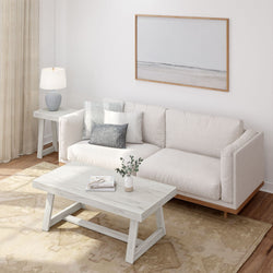 Modern Scandinavian living room with beige sectional sofa, light wood coffee table, neutral area rug, table lamp and minimalist framed wall art
