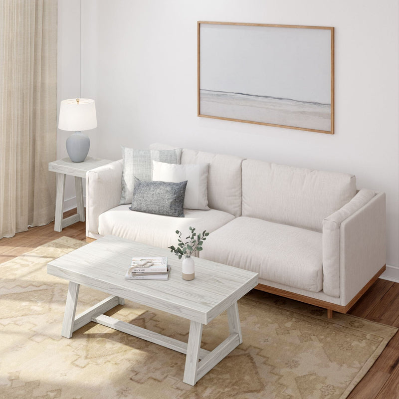 Modern Scandinavian living room with beige sectional sofa, light wood coffee table, neutral area rug, table lamp and minimalist framed wall art