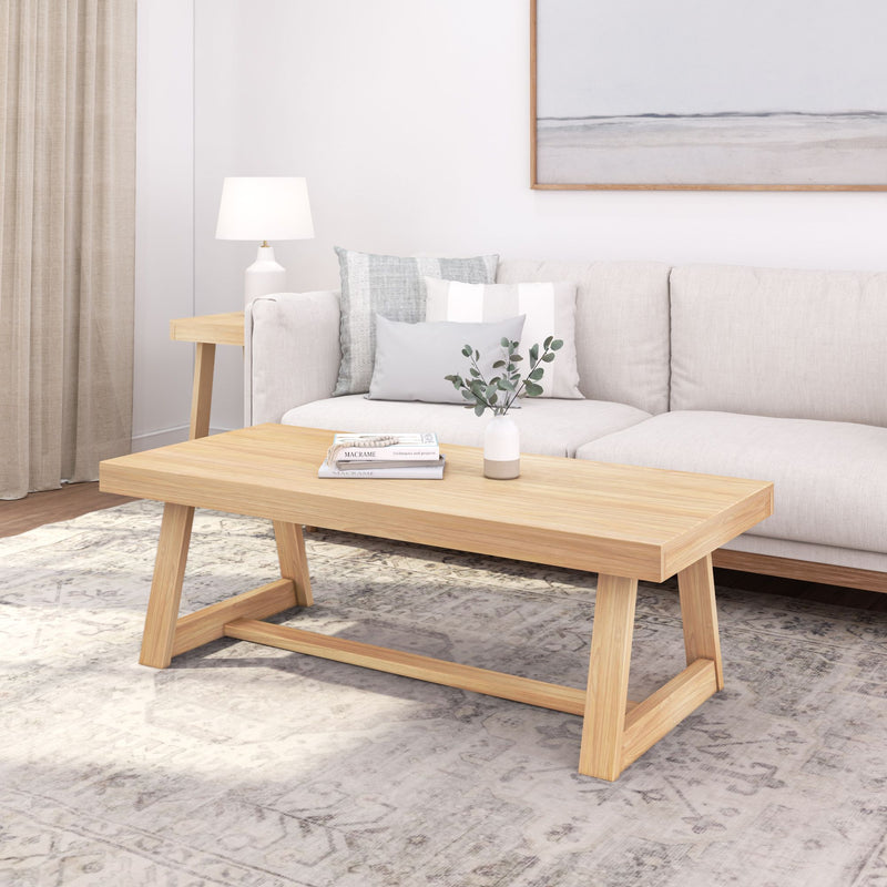 Modern living room with a minimalist wooden coffee table, beige sofa, and elegant decor accents.