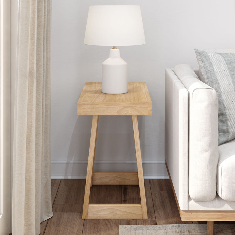 Minimalist living room with a wooden side table and modern white lamp.