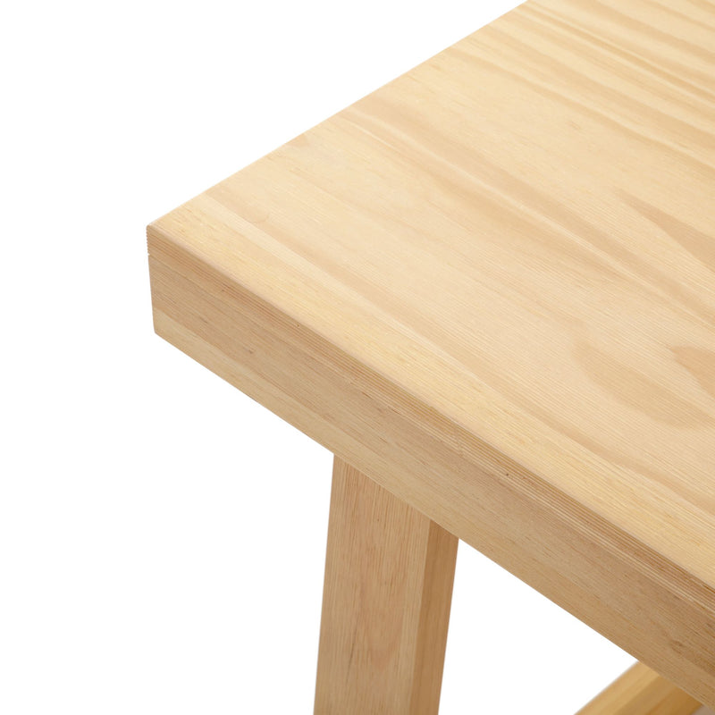 Minimalist wooden table with light natural finish, close-up view.