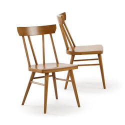 Pair of mid-century modern wooden dining chairs with spindle backs, tapered legs and warm oak finish – set of 2