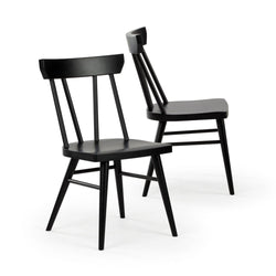 Two black wooden spindle-back dining chairs with matte finish, modern minimalist Scandinavian design, solid wood seats and tapered legs on white background