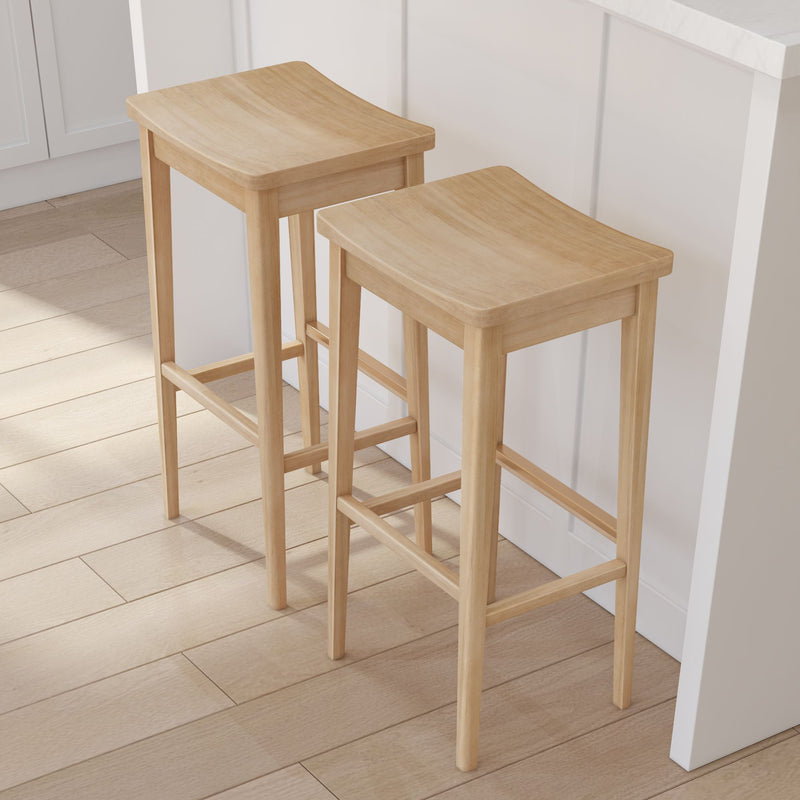 Pair of light oak backless wooden bar stools with natural wood grain at a white kitchen island, minimalist Scandinavian counter-height seating