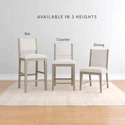 Set of upholstered dining chairs and stools in light wood with neutral beige fabric — bar stool, counter stool, dining chair available in 3 heights
