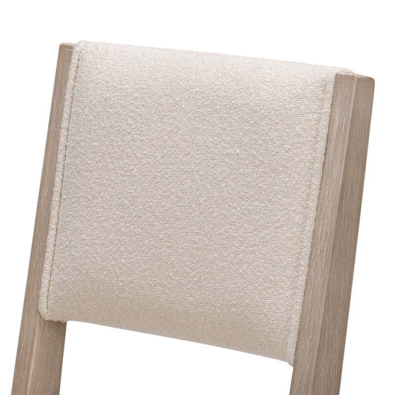 Close-up of beige textured upholstered dining chair back with light oak wood frame