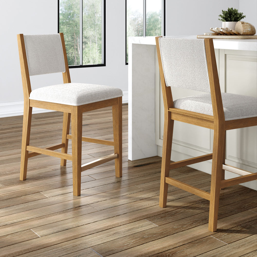 Wooden bar stools with cushioned seats in a modern kitchen setting with hardwood flooring.