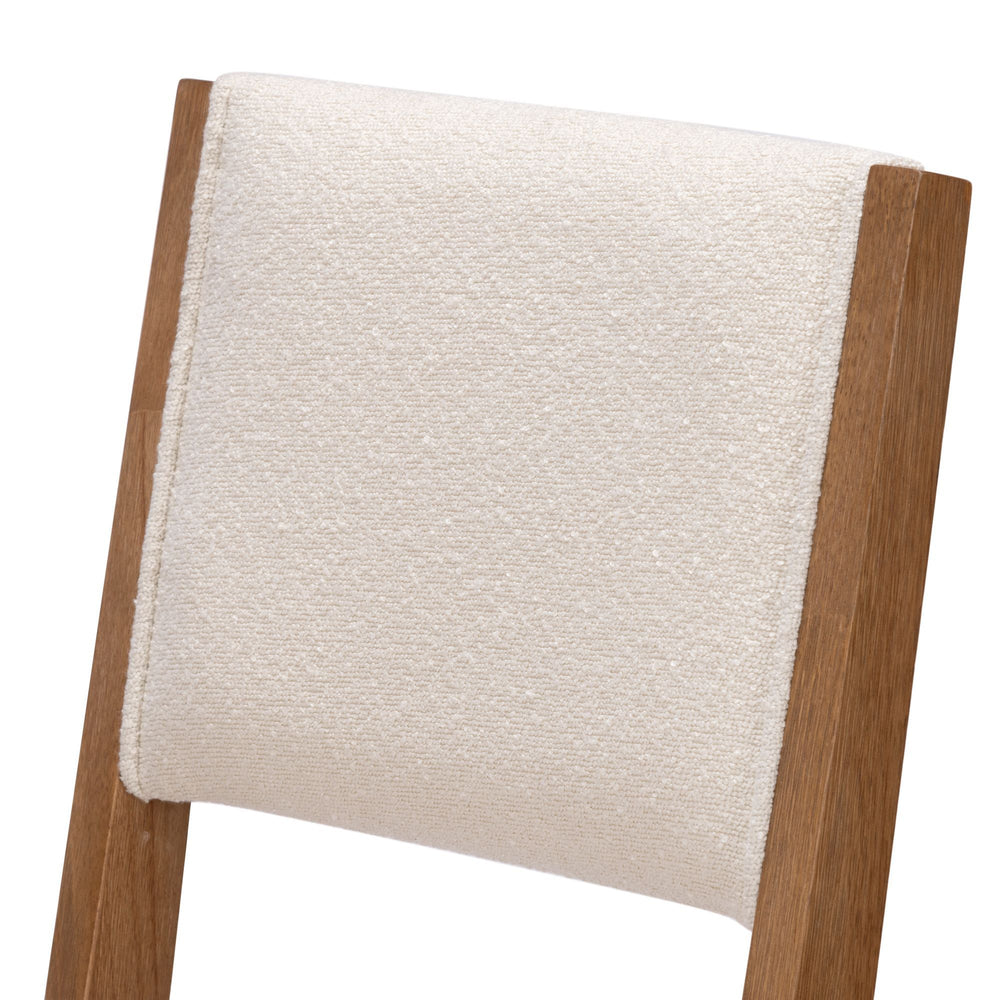 Beige upholstered wooden chair backrest close-up.