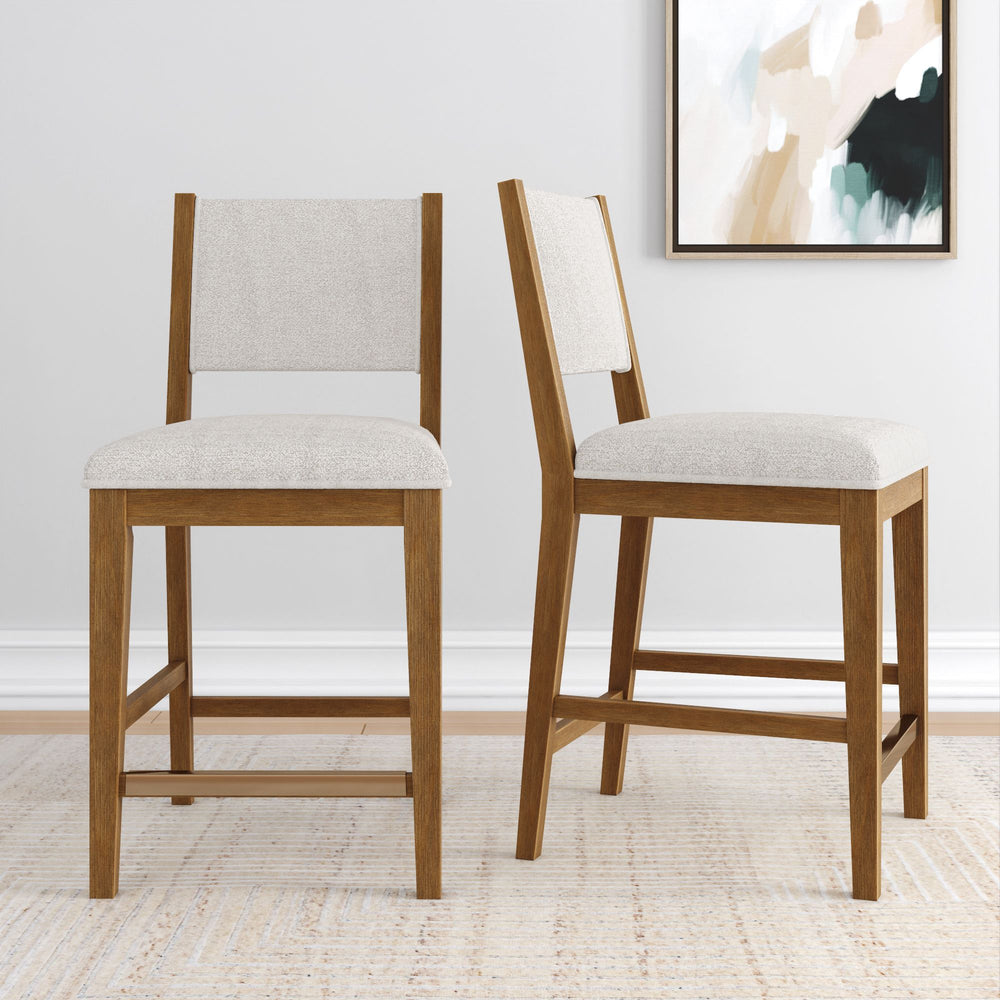 Pair of modern wooden dining chairs with beige upholstery in a contemporary living space.