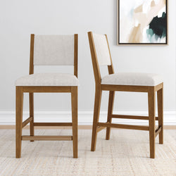 Pair of modern wooden dining chairs with beige upholstery in a contemporary living space.