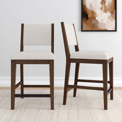 Elegant wooden dining chairs with beige upholstery in a modern living room setting.